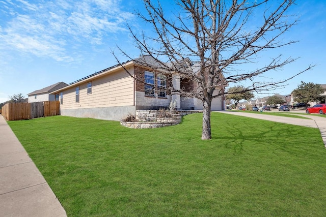 view of home's exterior with a garage, a lawn, driveway, and fence