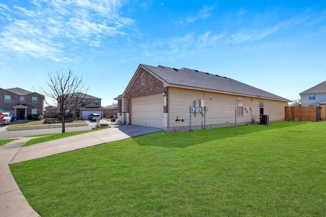 view of property exterior featuring fence, central AC unit, concrete driveway, a lawn, and brick siding