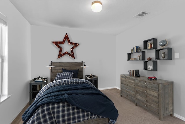 carpeted bedroom featuring visible vents and baseboards