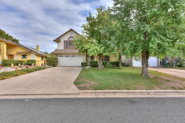 view of front facade featuring an attached garage, concrete driveway, and a front lawn