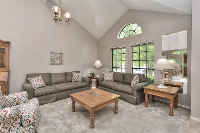 carpeted living area featuring a notable chandelier, high vaulted ceiling, and baseboards