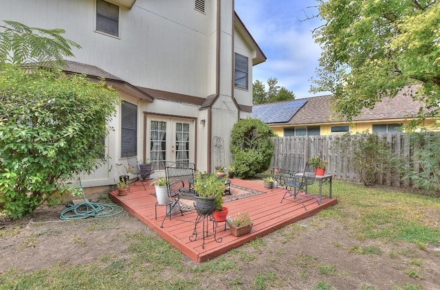 deck with french doors and fence