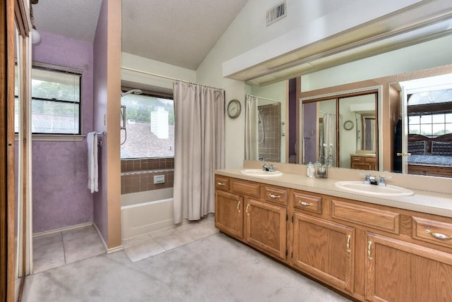 full bath featuring lofted ceiling, visible vents, tile patterned floors, and a sink