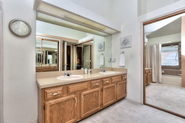 full bathroom with a sink and double vanity