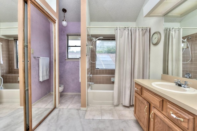 full bath featuring toilet, shower / tub combo with curtain, a textured ceiling, tile patterned flooring, and vanity