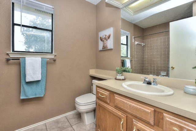 bathroom featuring vanity, baseboards, tile patterned flooring, walk in shower, and toilet