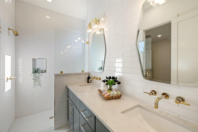 full bath featuring double vanity, tile walls, walk in shower, and a sink