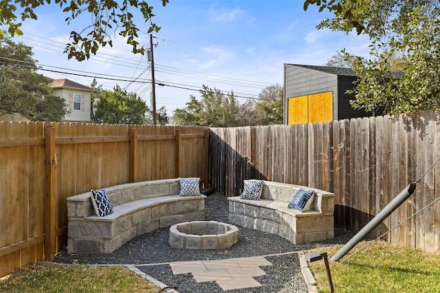 view of patio / terrace with a fenced backyard and an outdoor fire pit