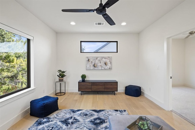 sitting room featuring a ceiling fan, wood finished floors, baseboards, and visible vents