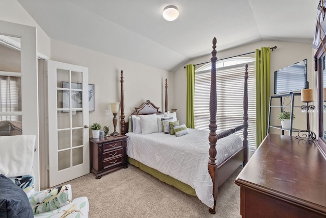 bedroom with vaulted ceiling and light carpet