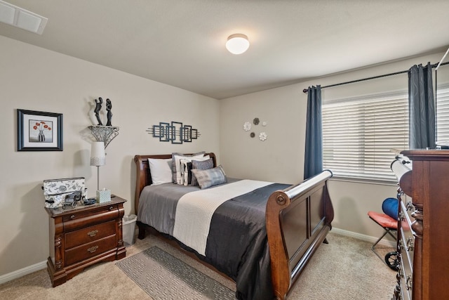 bedroom featuring light colored carpet, visible vents, and baseboards