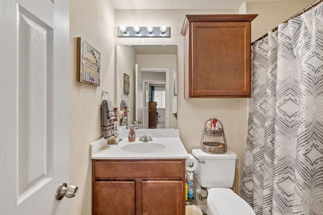 full bath featuring vanity and toilet