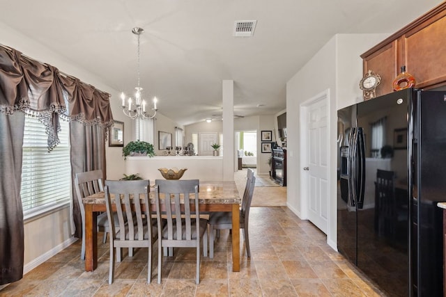 dining area featuring vaulted ceiling, baseboards, visible vents, and a chandelier