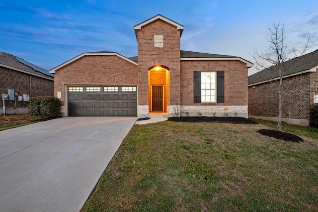 traditional home with brick siding, driveway, an attached garage, and a front lawn