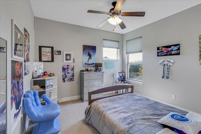 carpeted bedroom with ceiling fan and baseboards