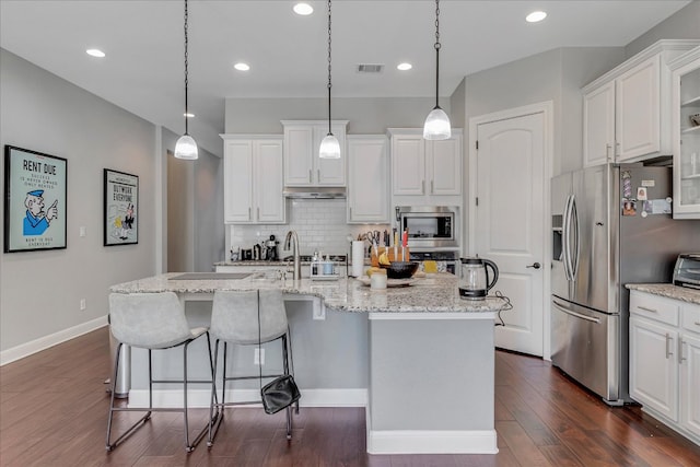 kitchen featuring visible vents, dark wood finished floors, appliances with stainless steel finishes, white cabinets, and decorative backsplash