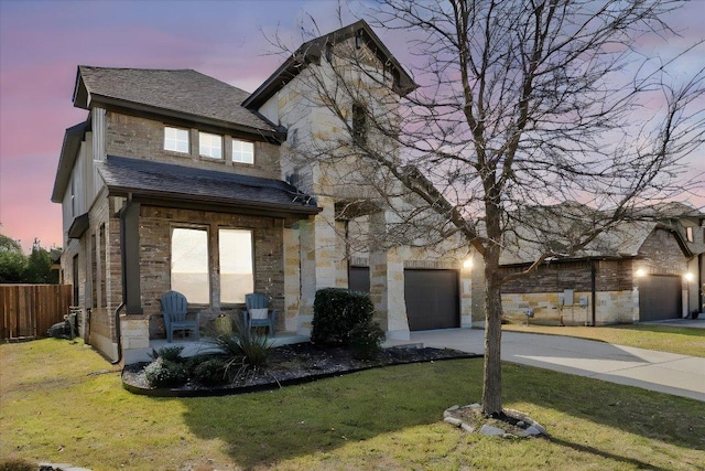 view of front of home with stone siding, driveway, and a front lawn