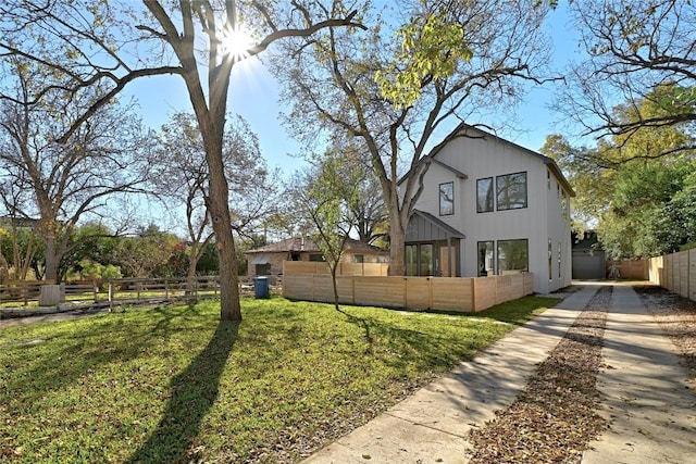 view of front facade featuring a front yard and fence private yard