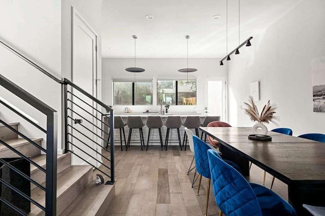 dining space with stairway and wood finished floors