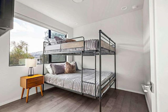 bedroom with baseboards and hardwood / wood-style flooring