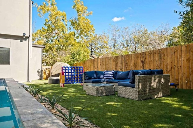 view of yard with outdoor lounge area and a fenced backyard