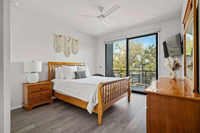 bedroom featuring access to exterior, a ceiling fan, and wood finished floors