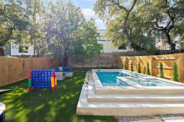 view of pool with a lawn, an in ground hot tub, and a fenced backyard