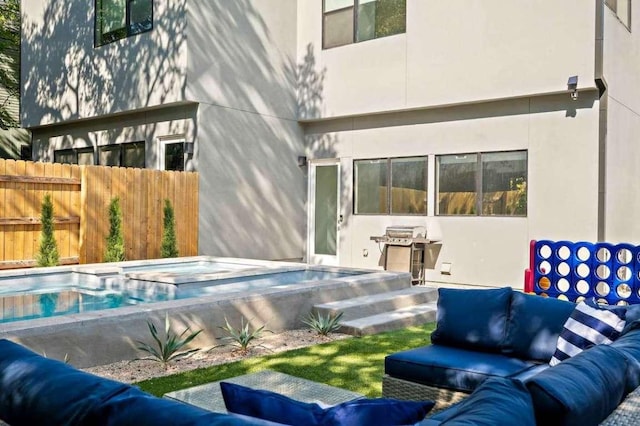 rear view of property with an outdoor hangout area, fence, and a hot tub