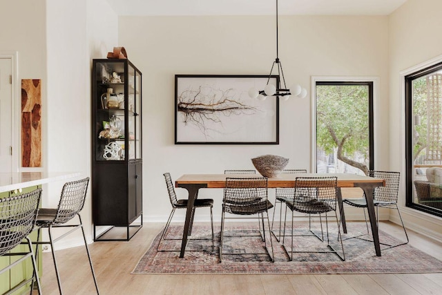 dining room with light wood-type flooring and baseboards