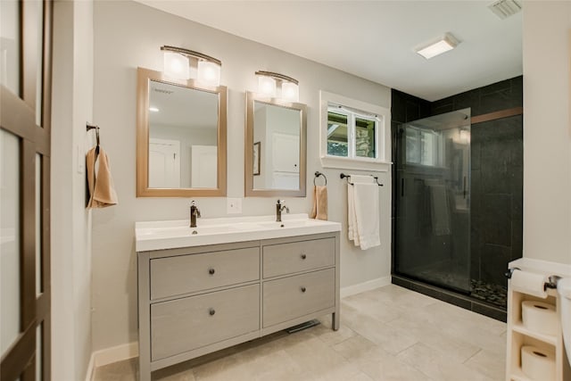 8603 Appalachian Dr, Austin, TX 78759 - bathroom featuring double vanity, a shower stall, baseboards, and tile patterned floors