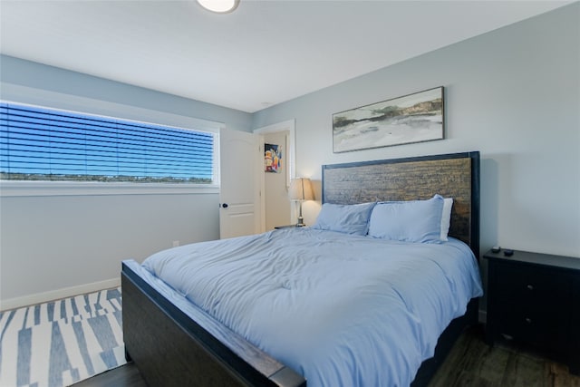 bedroom with wood finished floors and baseboards