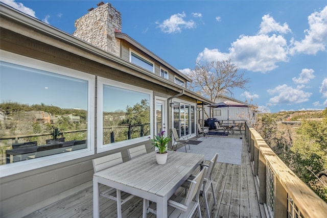 wooden deck with outdoor dining space