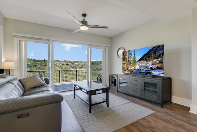 living room with baseboards, a healthy amount of sunlight, wood finished floors, and a ceiling fan