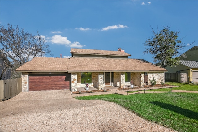 view of front of property with gravel driveway, a front yard, an attached garage, and fence