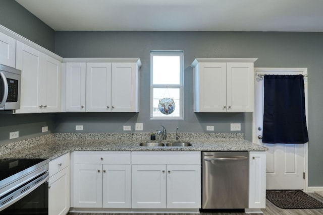 220 Wonderful Life Way, Jarrell, TX 76537 - kitchen with appliances with stainless steel finishes, white cabinets, and light stone counters