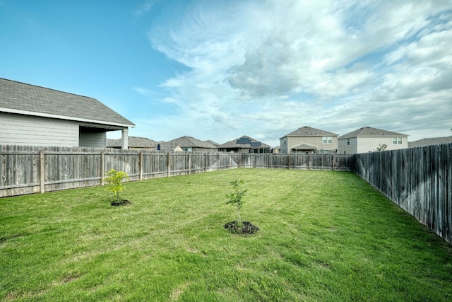 view of yard featuring a residential view and a fenced backyard