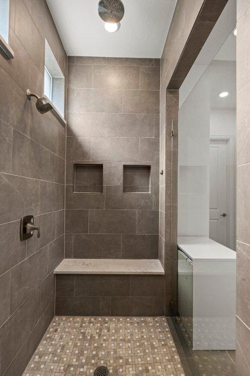 full bath featuring a tile shower