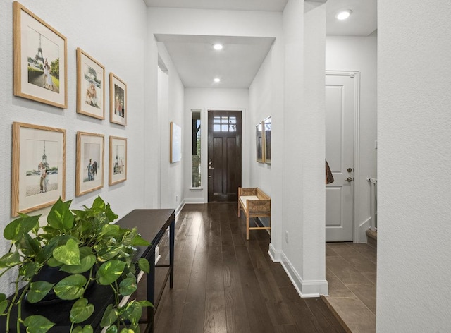 foyer entrance with baseboards and dark wood-style floors