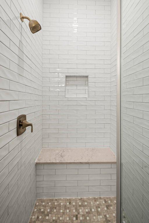 bathroom with tiled shower