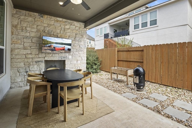 view of patio featuring outdoor dining space, a ceiling fan, and fence