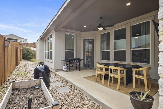 view of patio / terrace featuring ceiling fan and fence