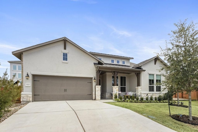 view of front of property with concrete driveway, a front yard, metal roof, stone siding, and a standing seam roof