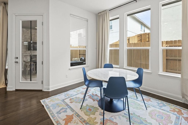 dining area featuring baseboards and wood finished floors