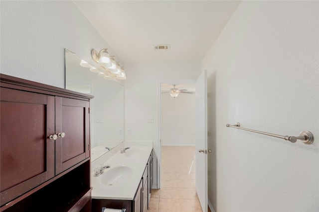 bathroom featuring tile patterned flooring, double vanity, visible vents, and a sink