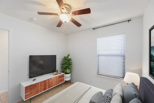 bedroom featuring tile patterned floors, baseboards, and ceiling fan