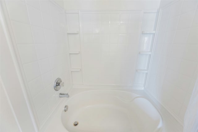 bathroom with bathing tub / shower combination