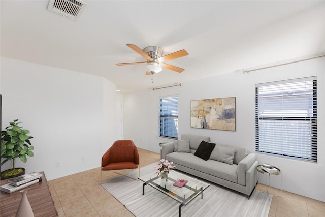 living room featuring light tile patterned flooring, visible vents, and a ceiling fan