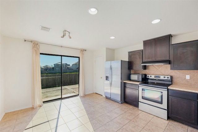 kitchen with visible vents, tasteful backsplash, stainless steel appliances, dark brown cabinetry, and light countertops