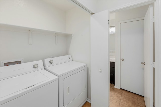 laundry area featuring washer and dryer, laundry area, and light tile patterned floors