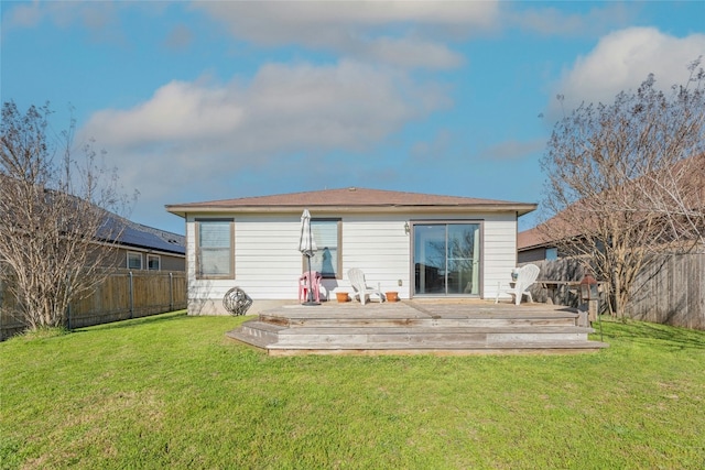 back of house with a yard, a deck, and a fenced backyard